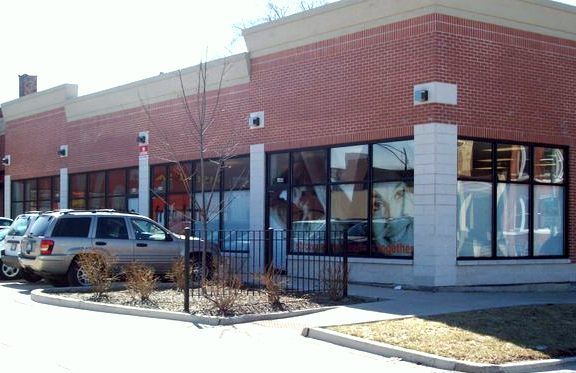 A brick building with cars parked in front of it