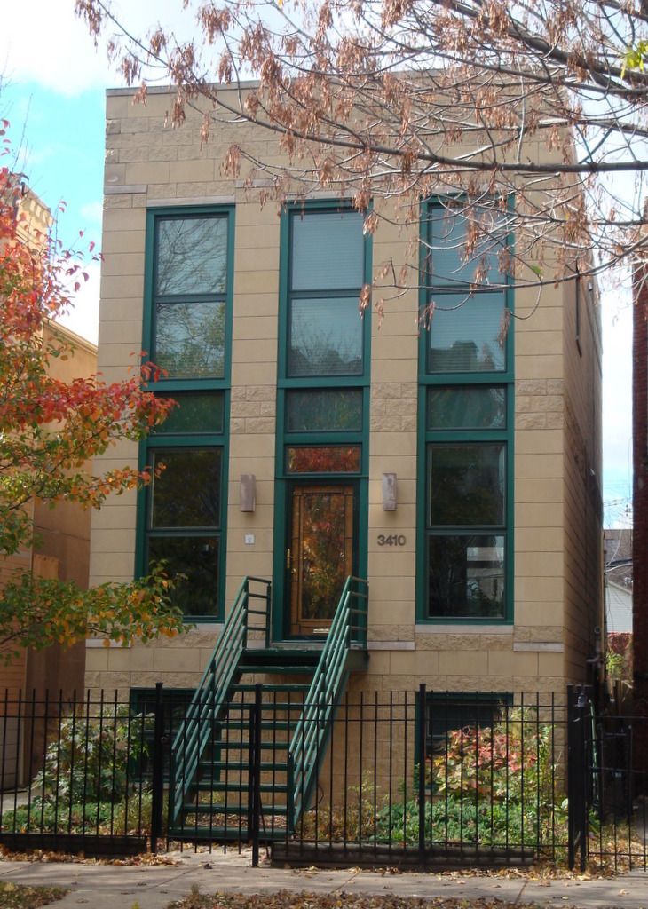 A large building with stairs leading up to the front door