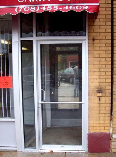 A store front with a red awning that says ( 708 ) 485-4609