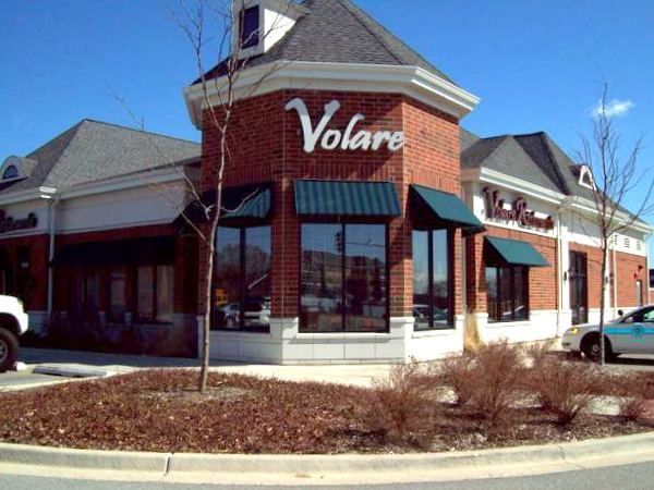 A brick building with the word volare on it