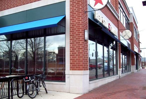 A brick building with a sign that says heineken on it