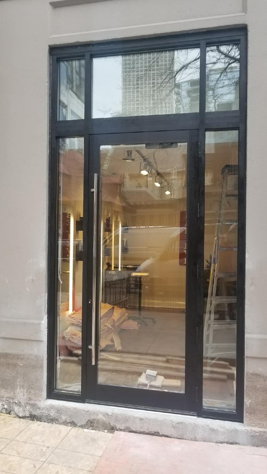 A large glass door is open to a store.