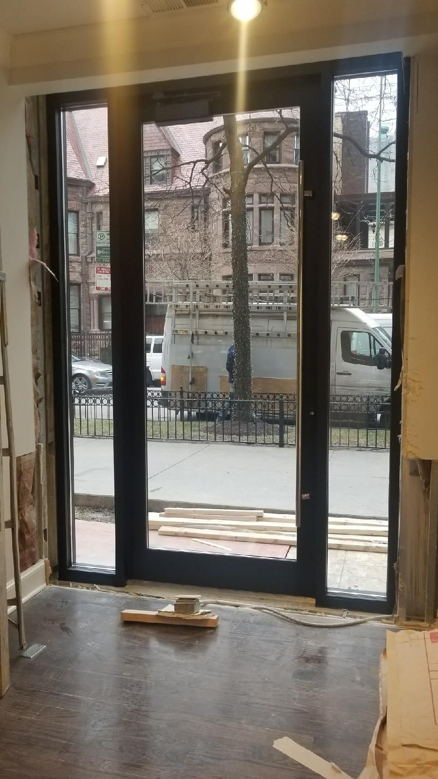 A room with a sliding glass door and a view of a street.