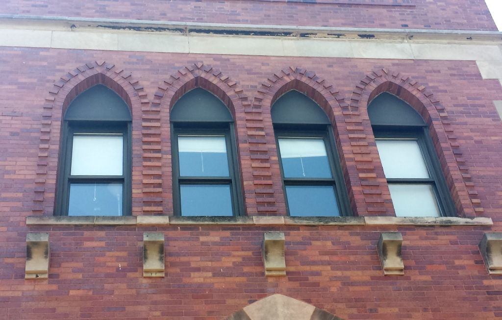 A brick building with arched windows on the side