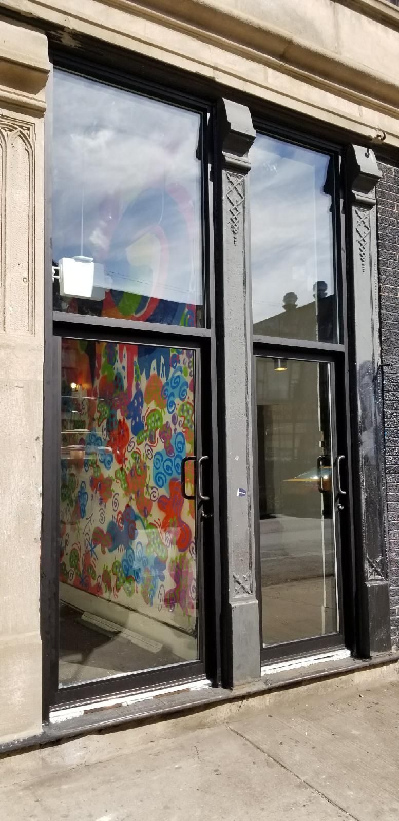 A building with a lot of windows and a painting on the side of it.