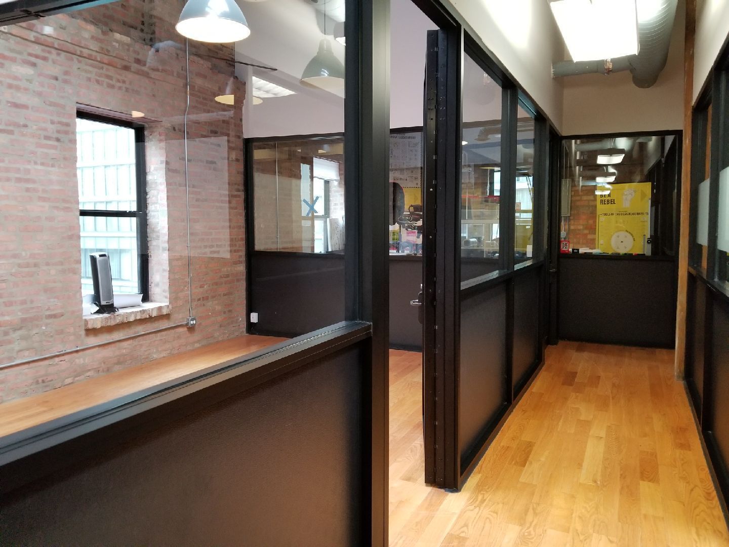A hallway with a lot of windows and a wooden floor