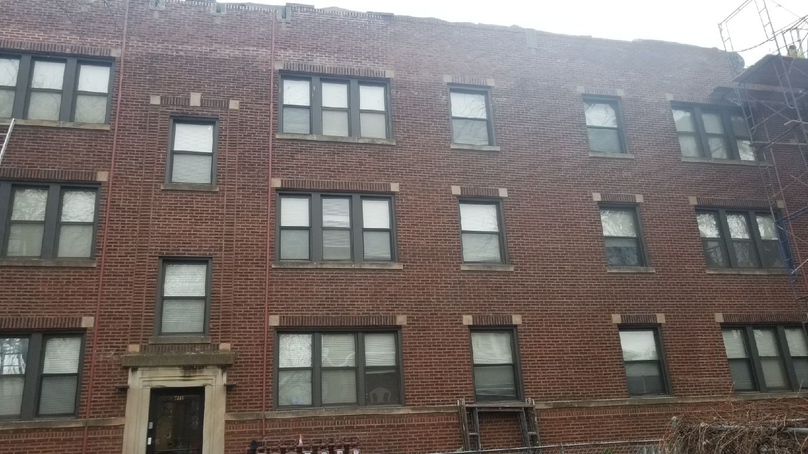 A large brick building with many windows and a fire escape