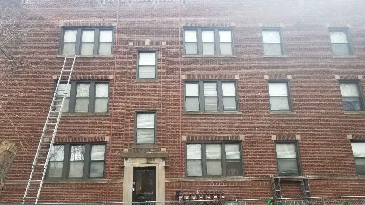A brick building with a fire escape on the side of it.