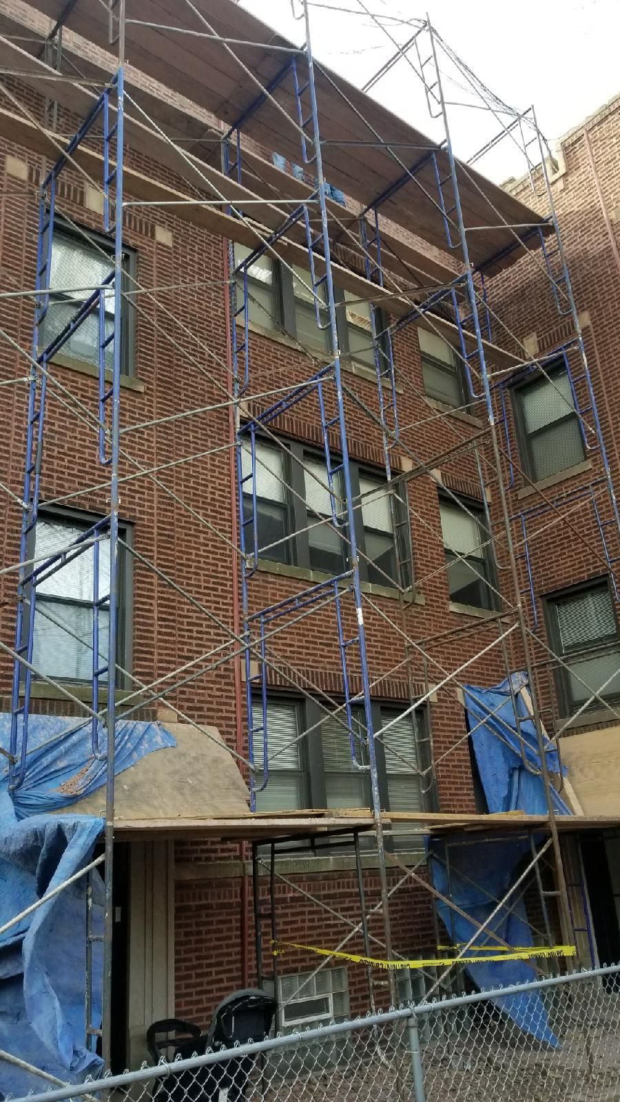A brick building with scaffolding on the side of it.