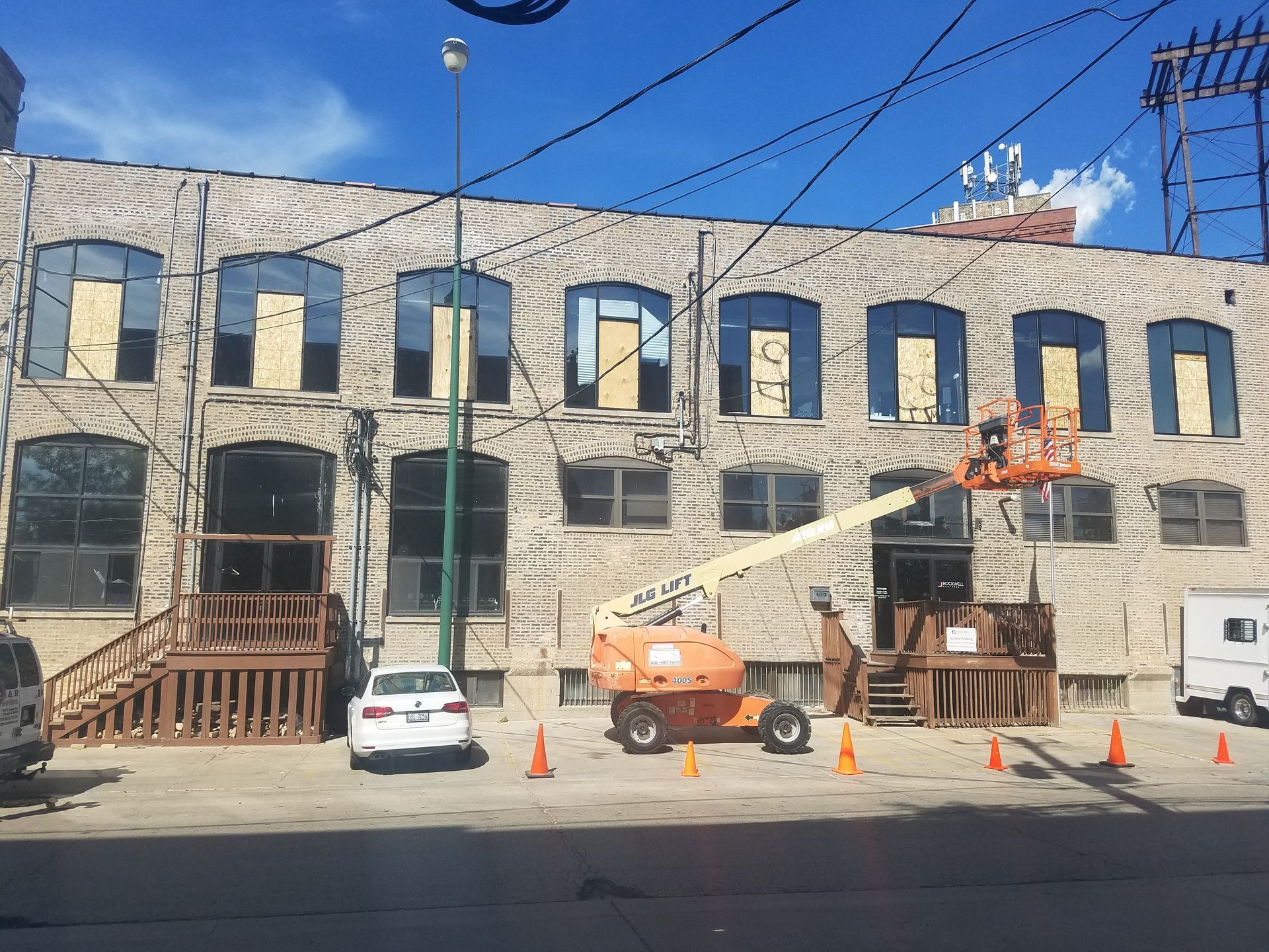 A large brick building with a lot of windows is being remodeled.