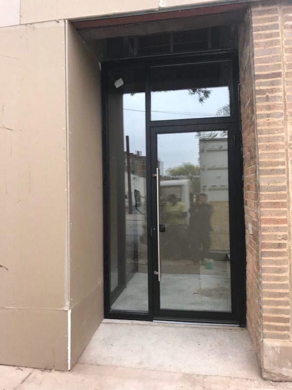A brick building with a large glass door