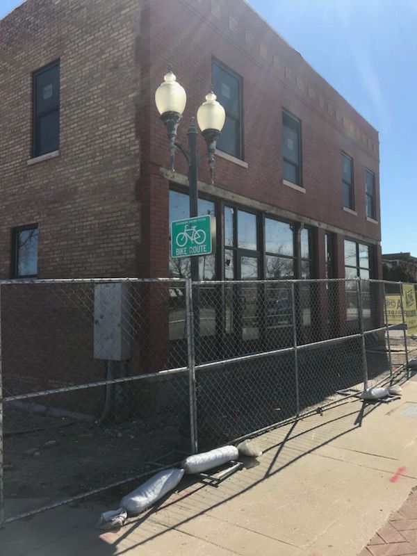 A brick building with a chain link fence around it