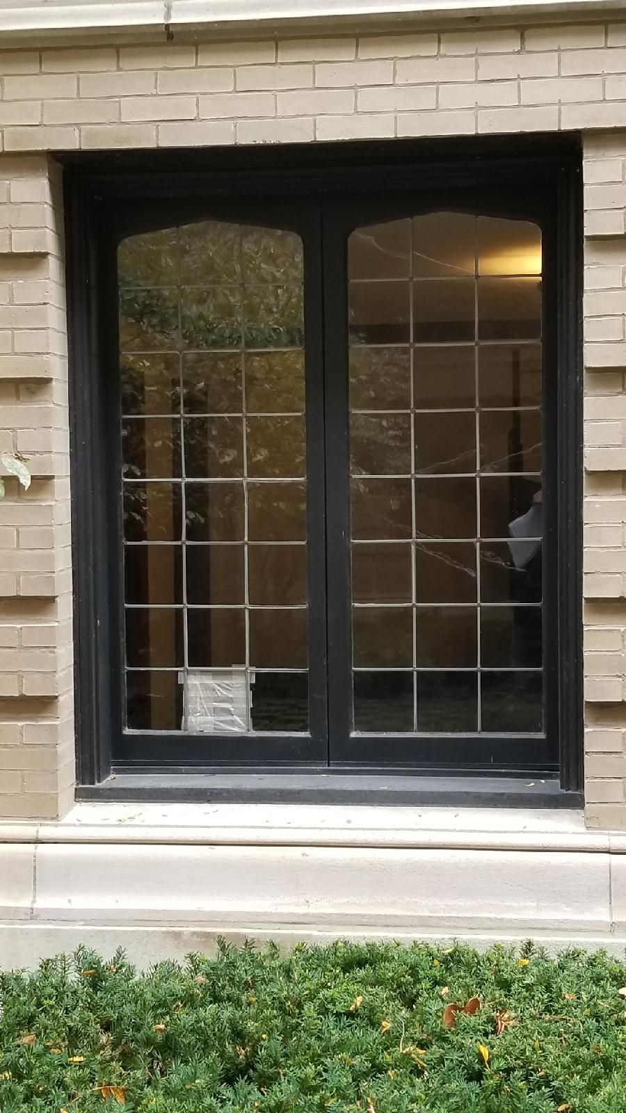 A large window on the side of a brick building.