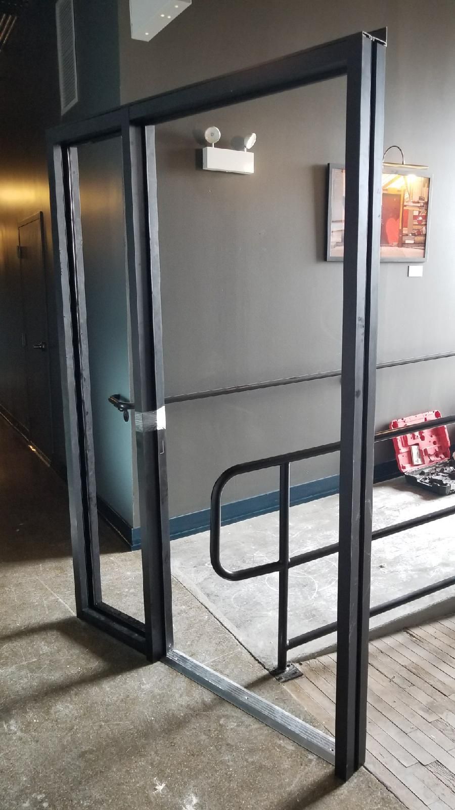 A door is open in a hallway with a railing.