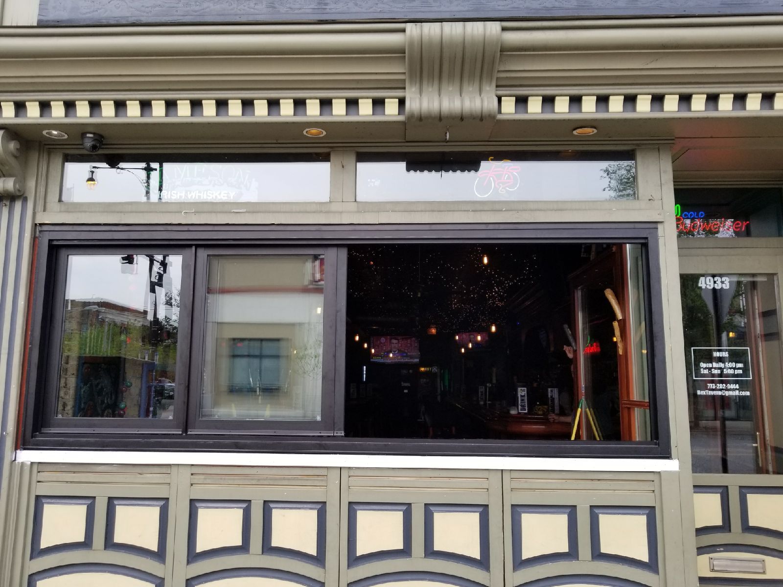 A building with a large window and a sign that says open