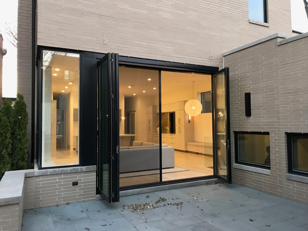 A large sliding glass door is open to a living room.