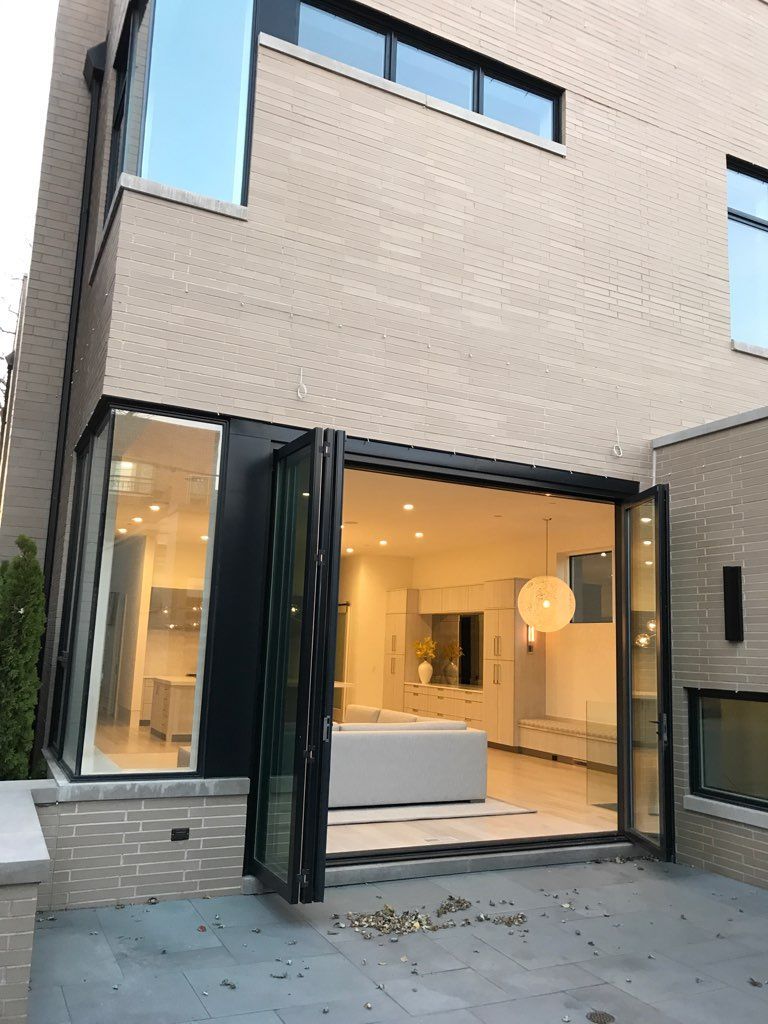 A house with a lot of windows and a couch in the living room