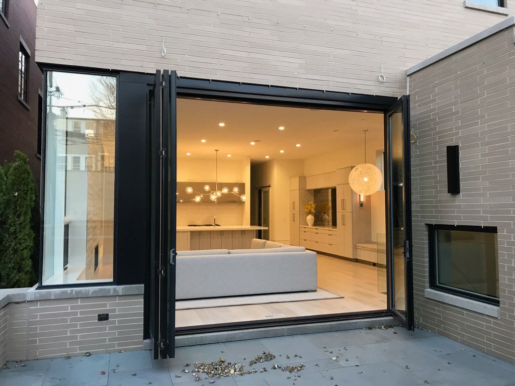 A house with a large sliding glass door leading to a living room and kitchen.