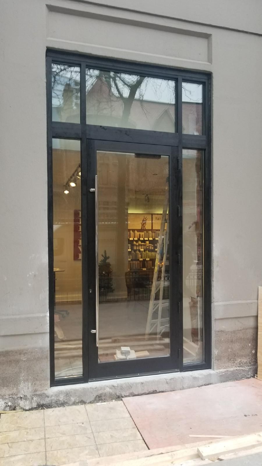 A large glass door is open to a store.