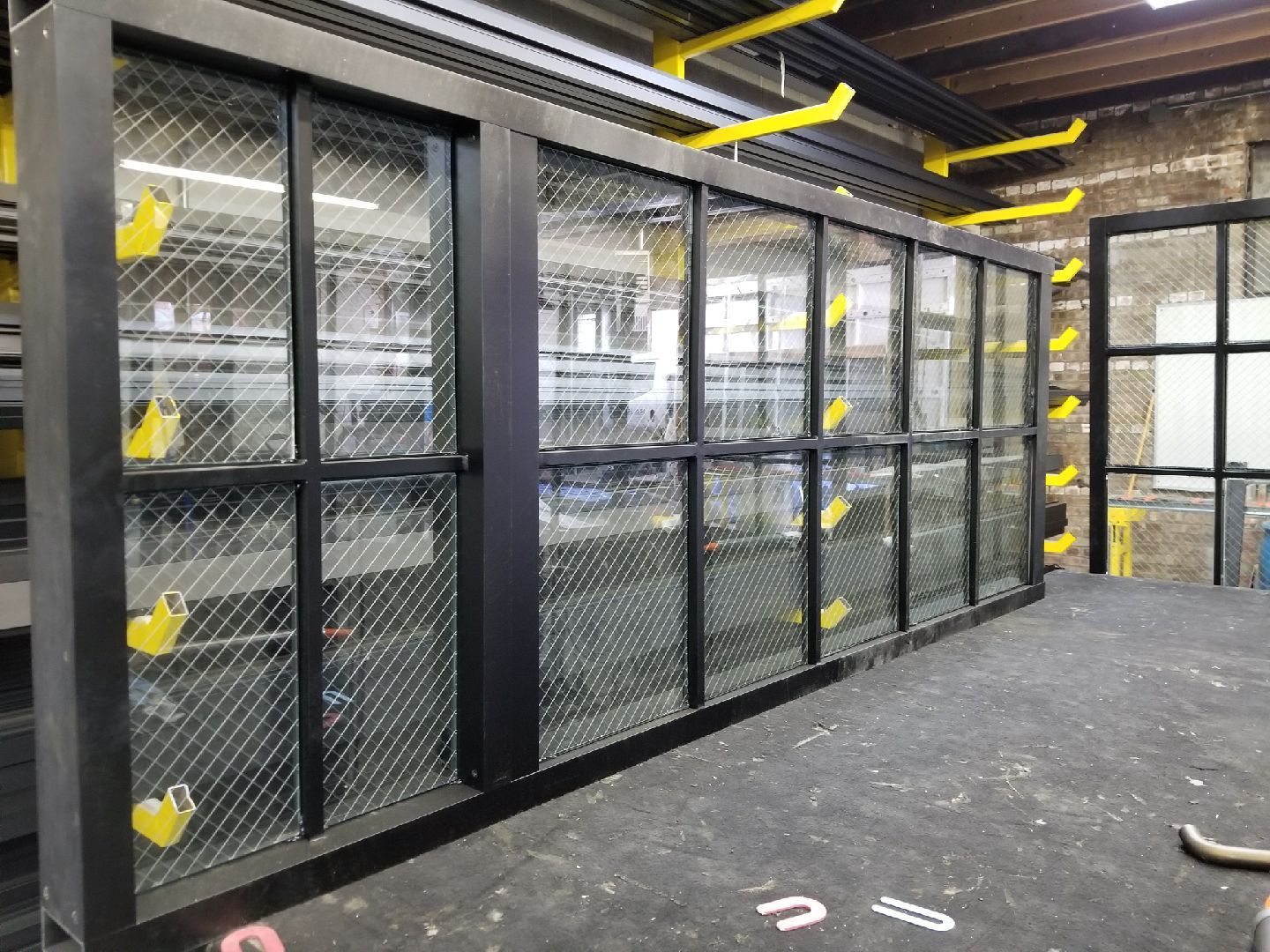 A row of sliding glass doors are sitting on top of a table.