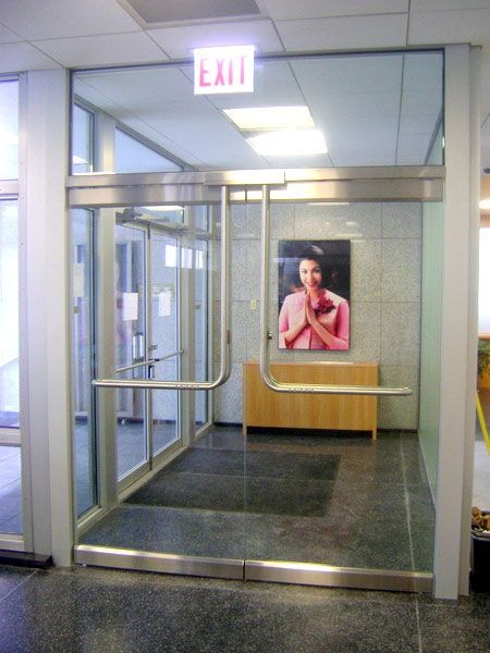 A glass door with an exit sign above it