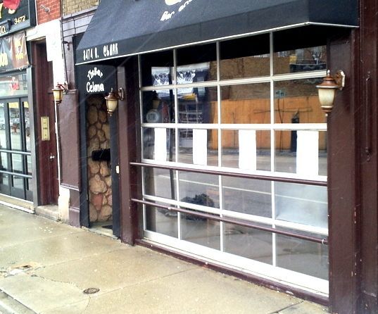 A store front with a black awning that says all bar