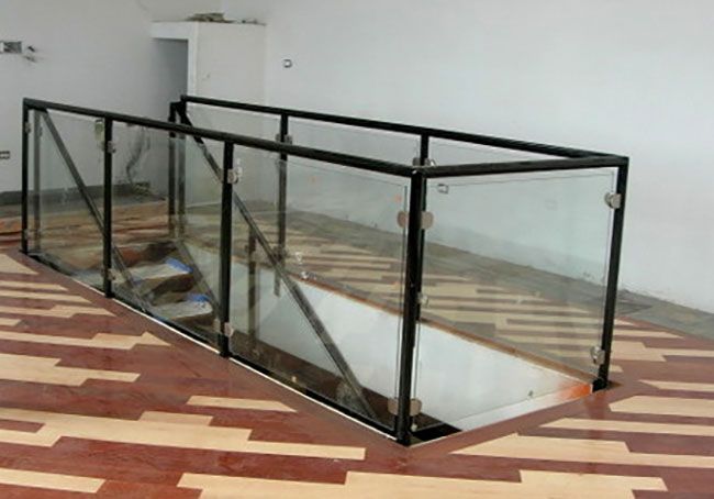 A staircase with a glass railing in a room