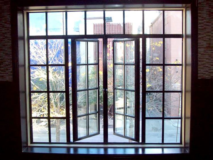 A large window with a view of a city and trees