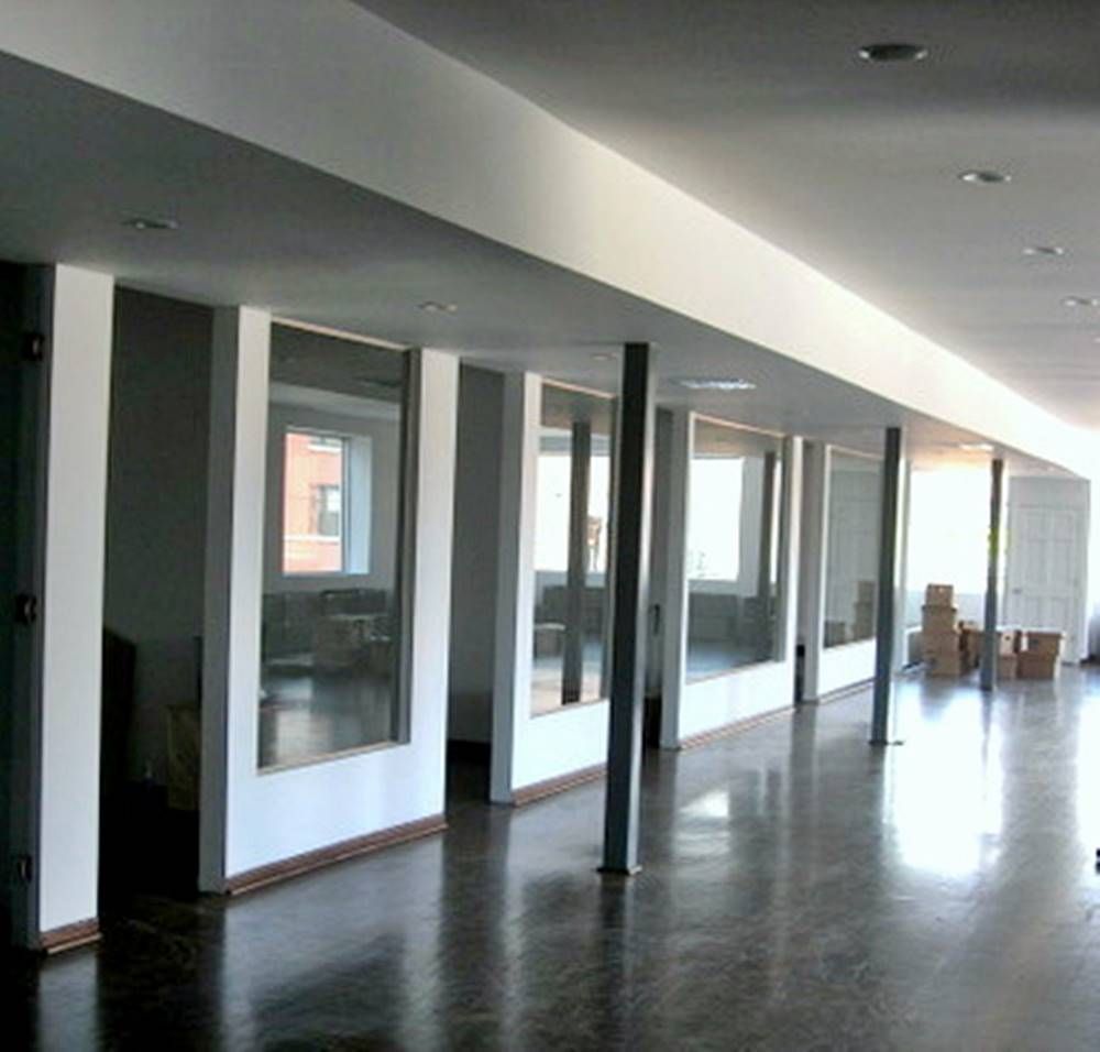 A long hallway with a lot of windows and boxes on the floor