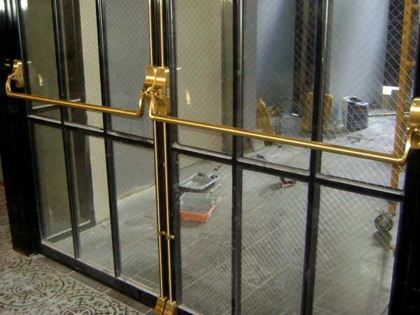 A sliding glass door with a gold handle