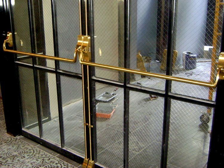 A black and gold door with a gold handle