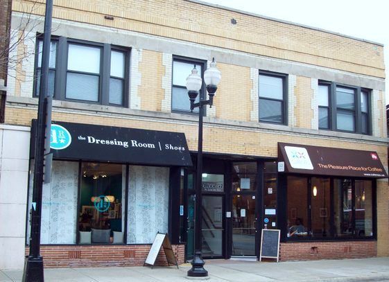 A building with a black awning that says dressing room