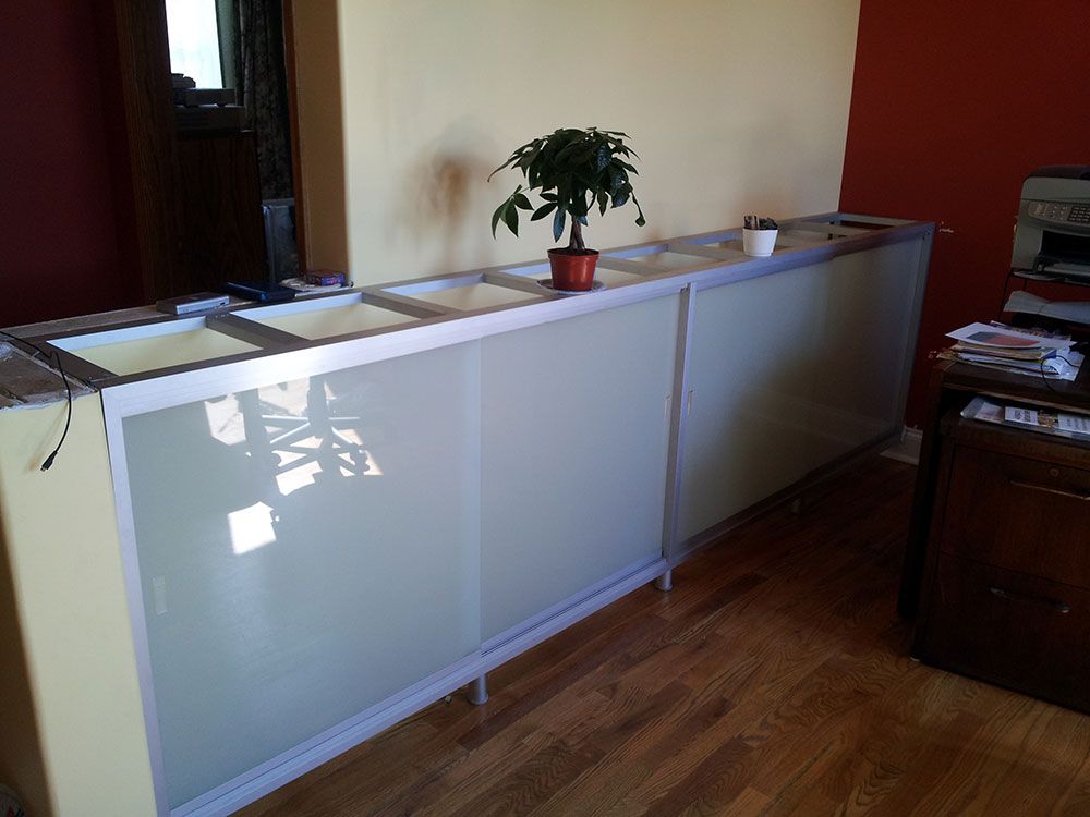 A potted plant sits on top of a white cabinet