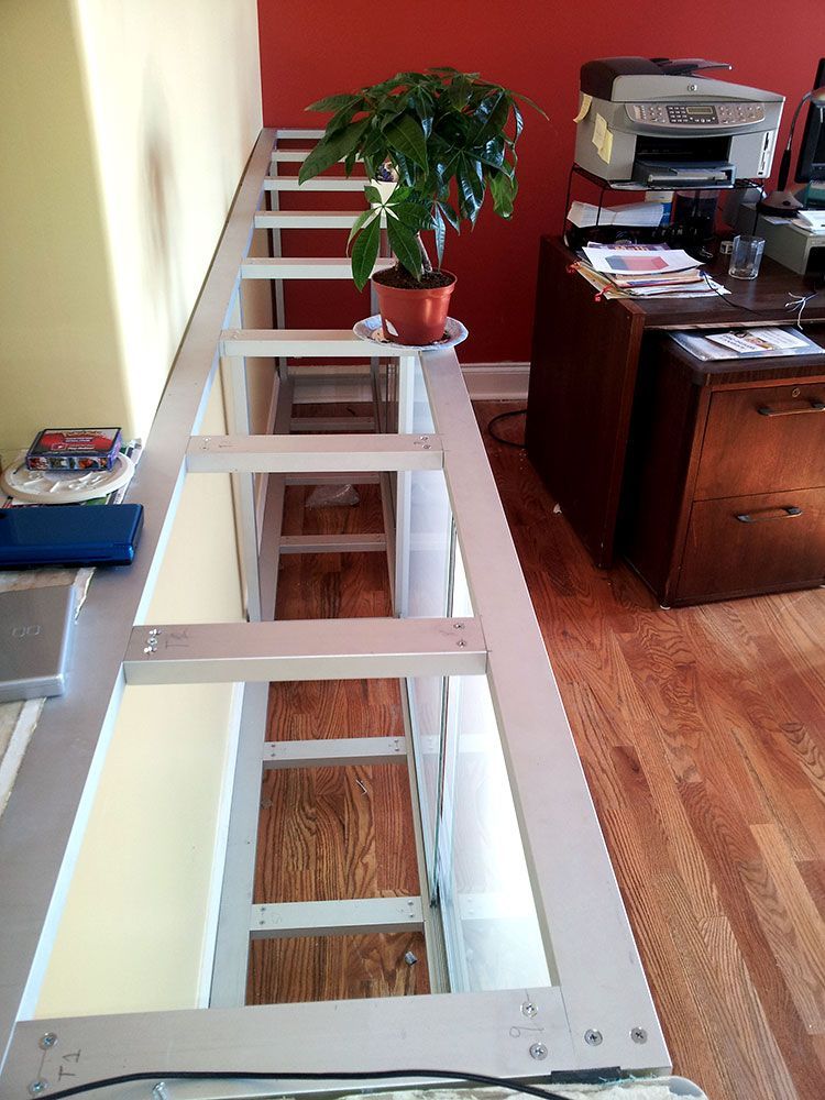 A desk with a printer and a potted plant on it