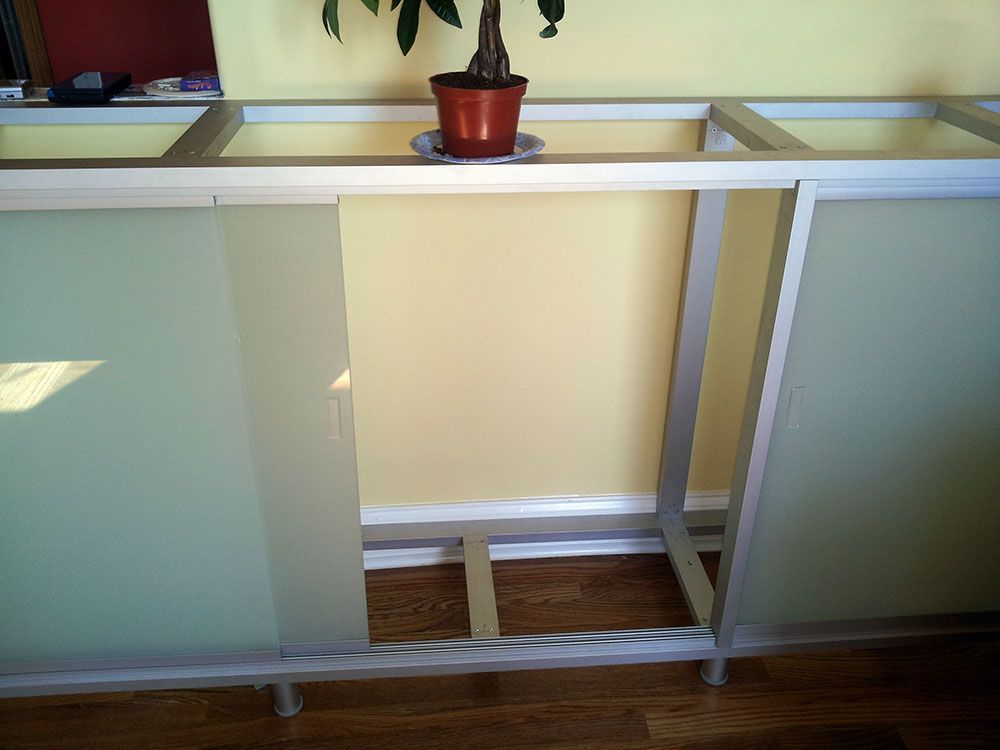 A potted plant sits on top of a glass shelf