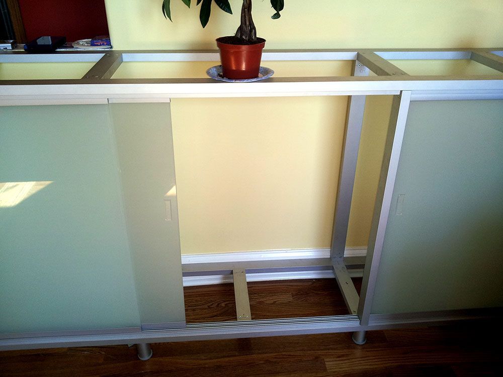 A potted plant sits on top of a glass shelf