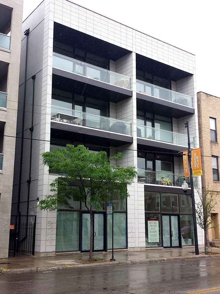 A building with a lot of windows and balconies on a rainy day