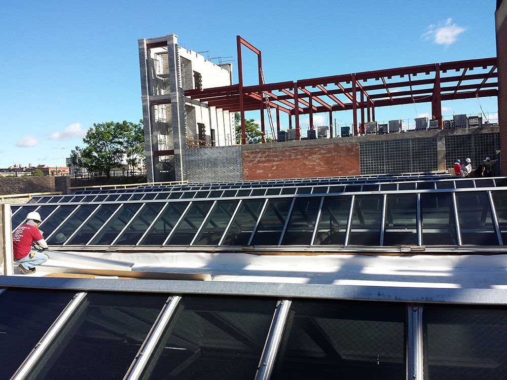 A man is working on the roof of a building