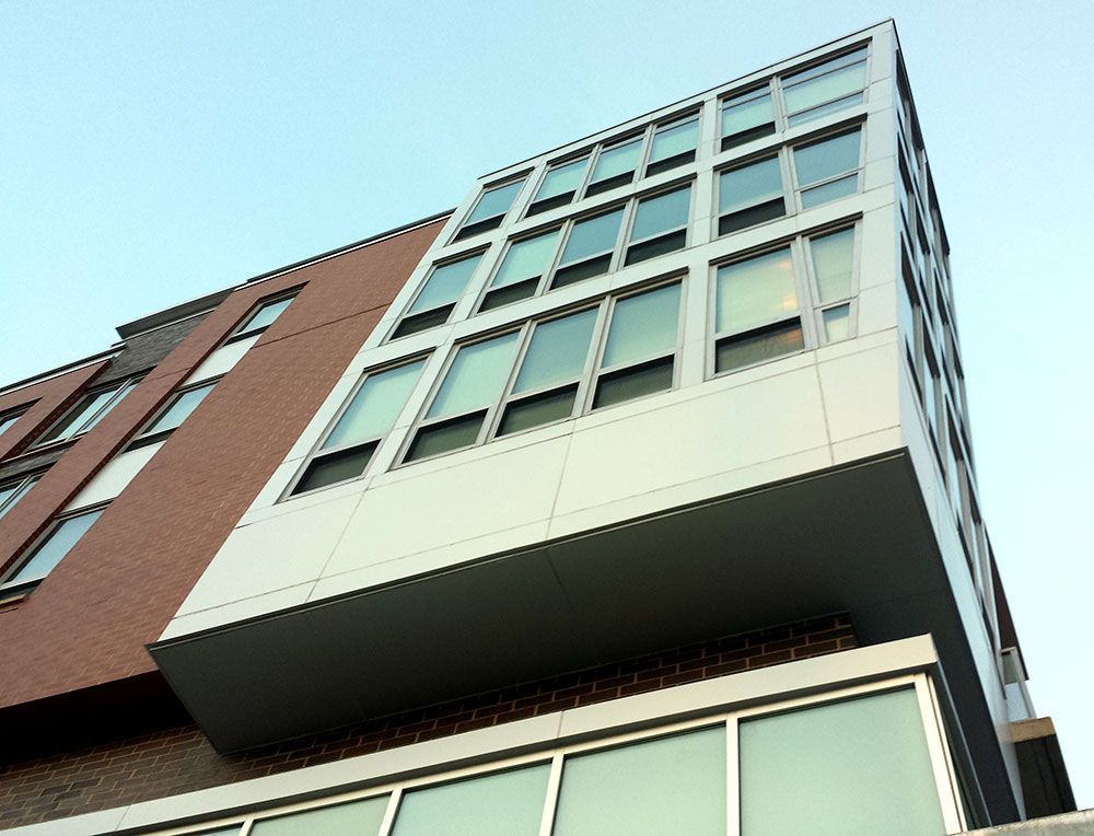 Looking up at a tall building with lots of windows