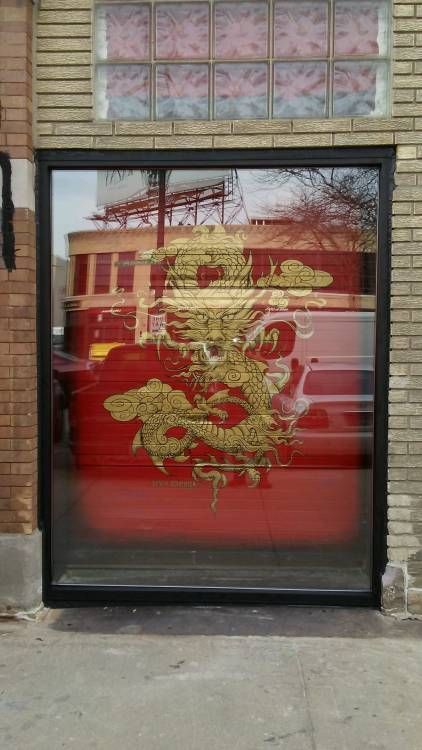 A large window with a picture of a dragon on it.