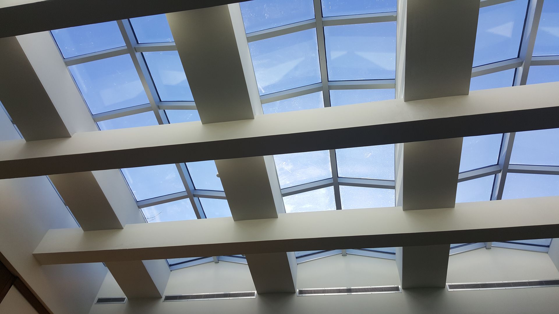 Looking up at the sky through a skylight in a building