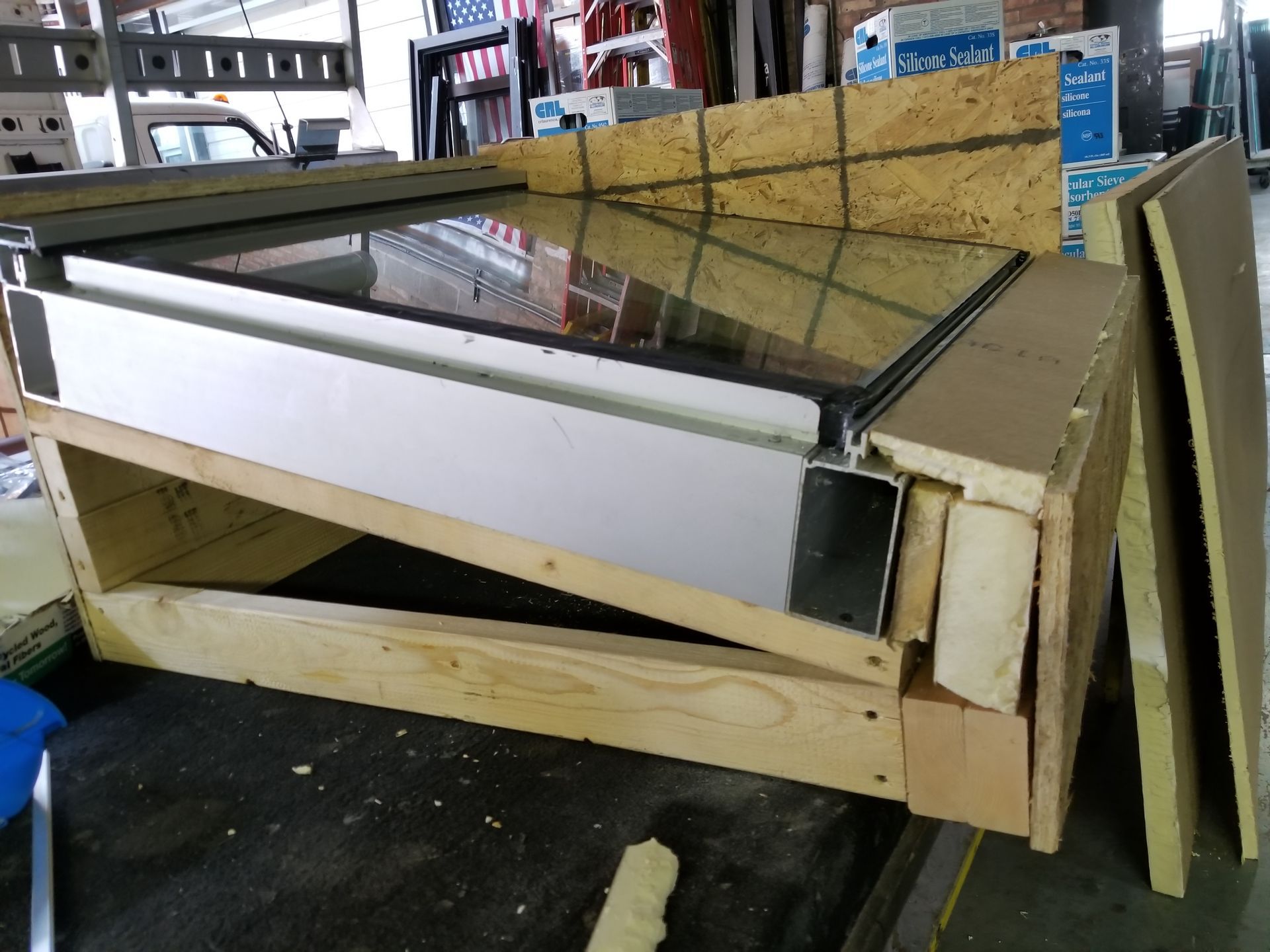 A wooden box with a stainless steel item in it