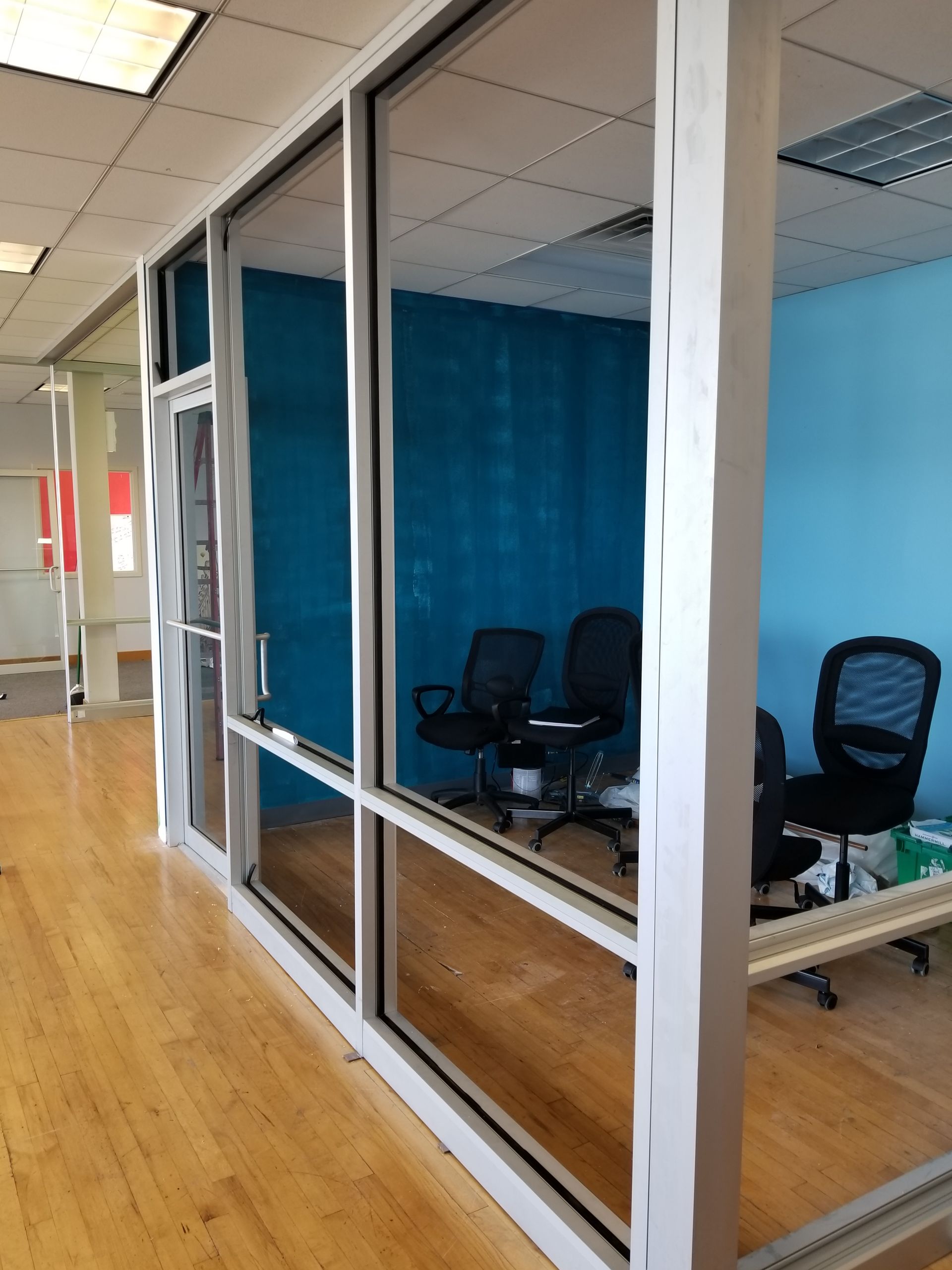 A room with a lot of windows and chairs