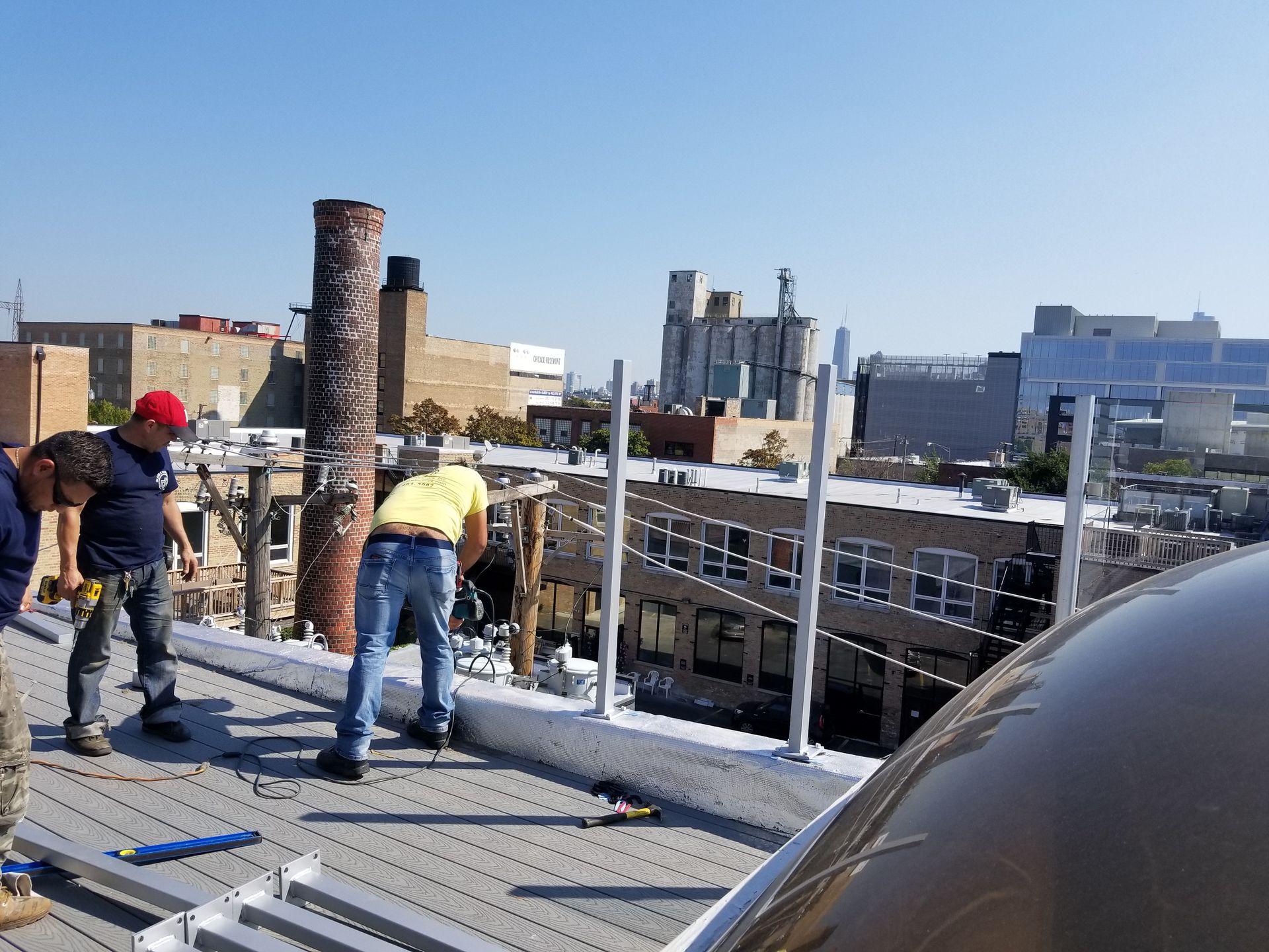 A group of men are working on the roof of a building.