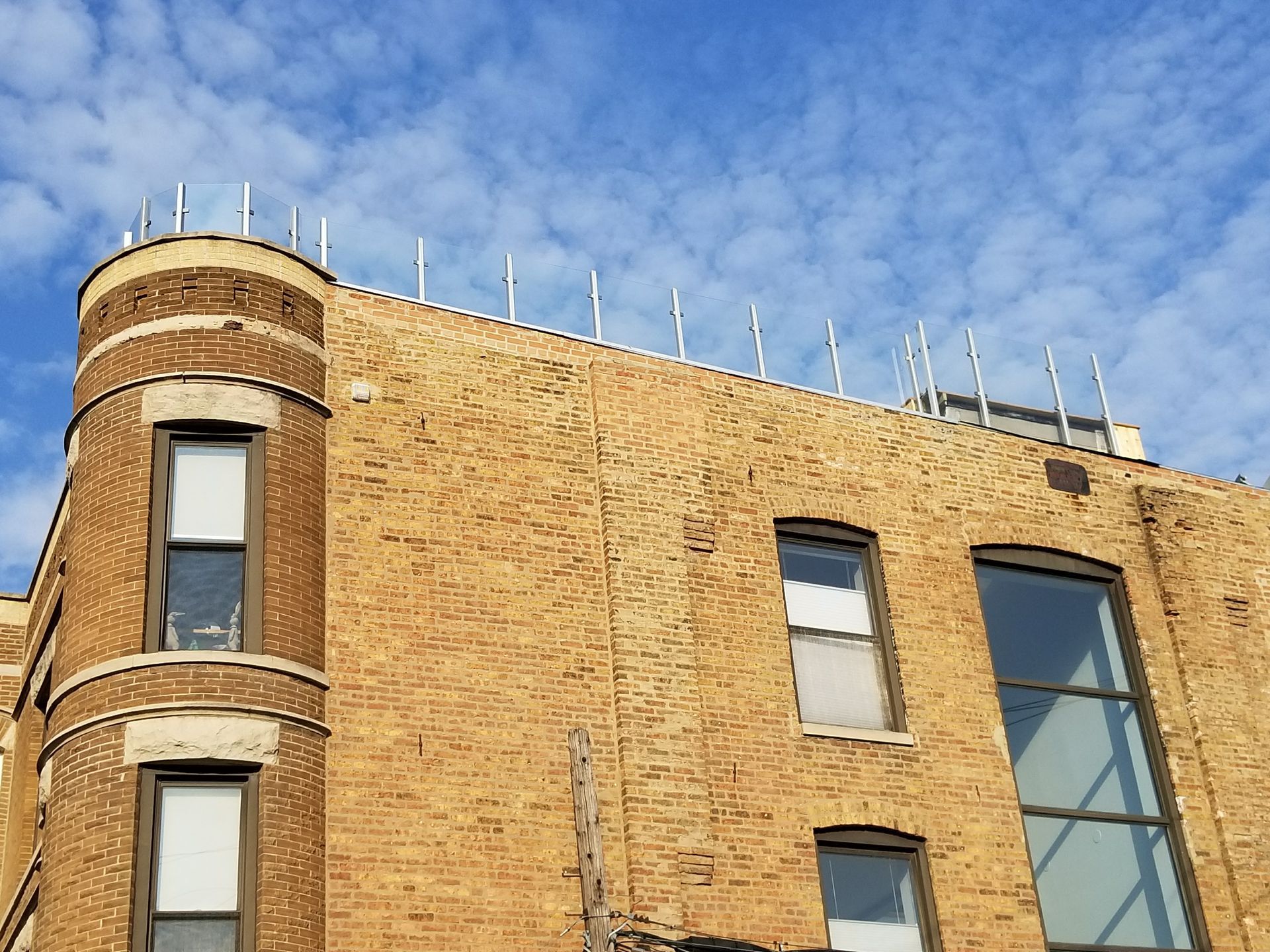 A large brick building with a blue sky in the background