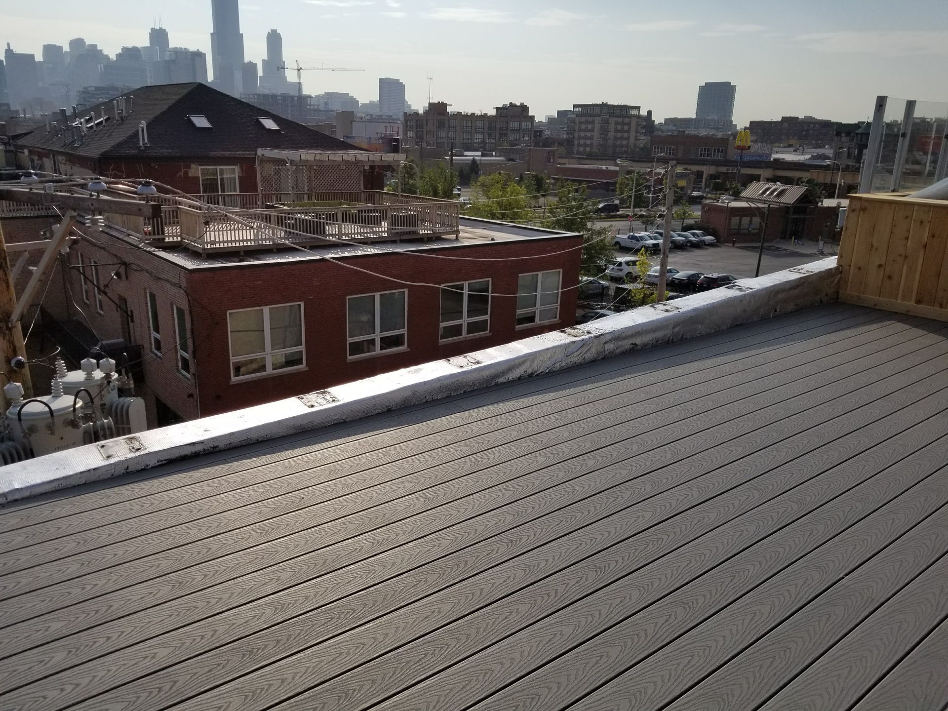 A rooftop deck with a view of a city.