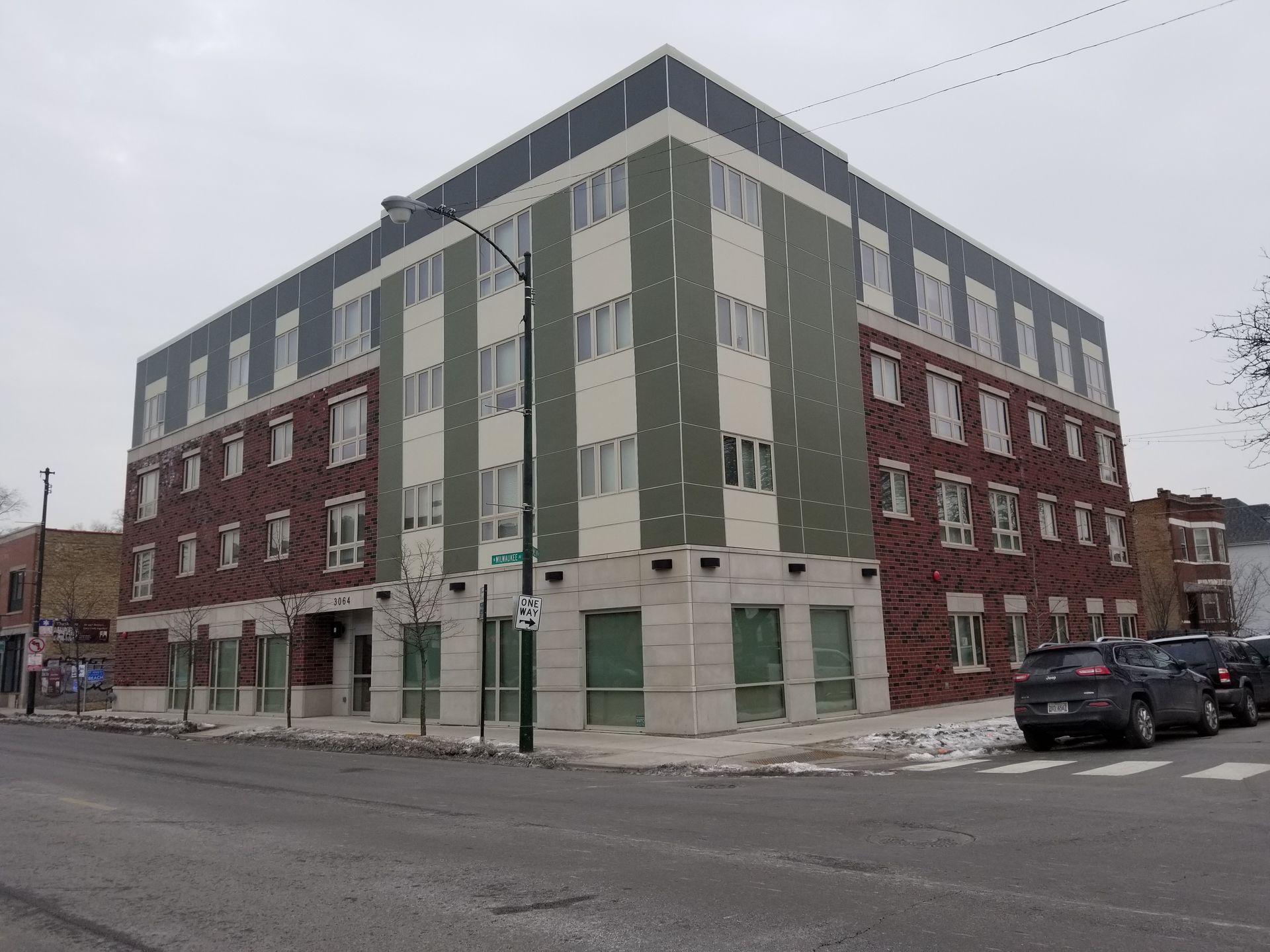 A large brick building with a green and white facade