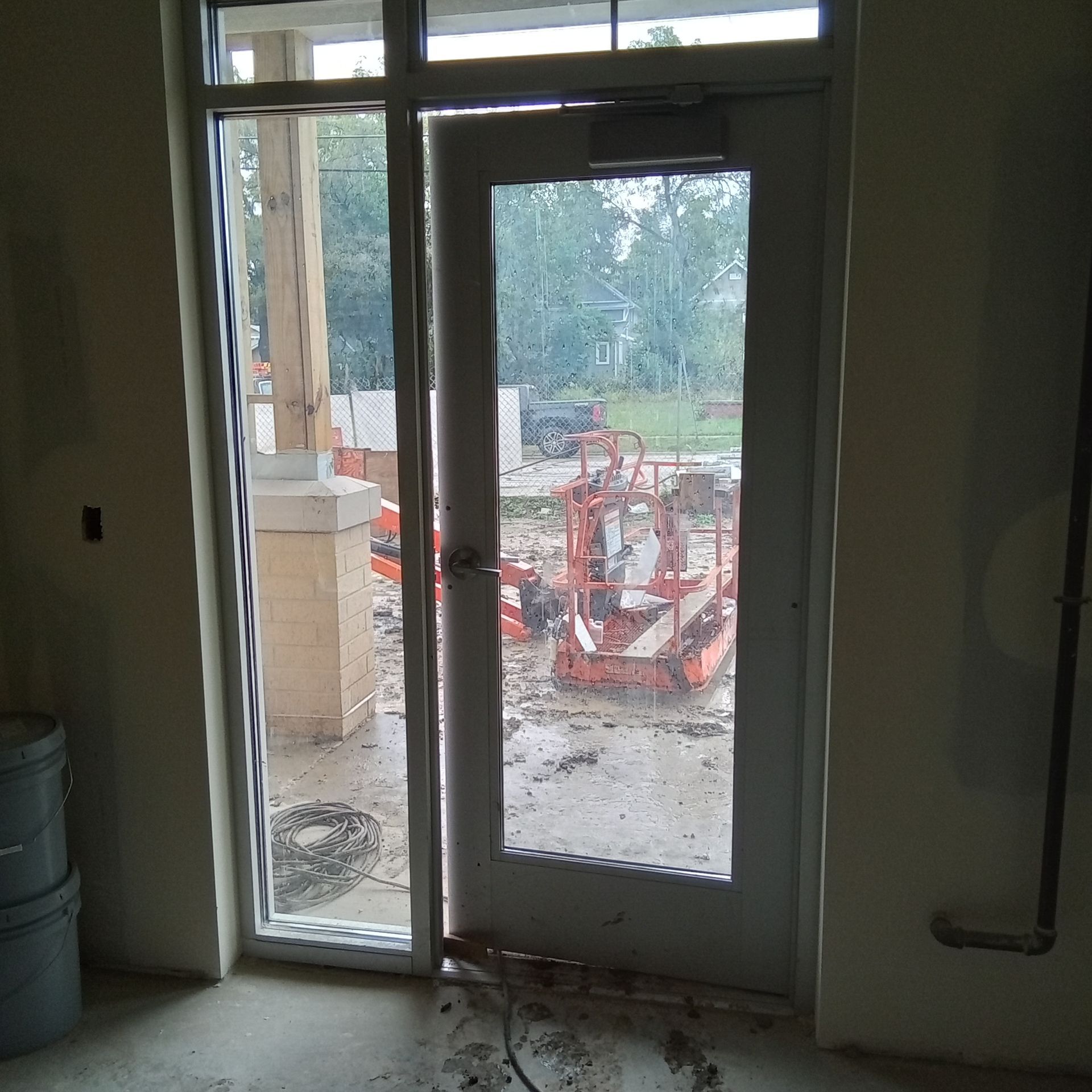 A door with a view of a construction site behind it