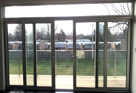 A room with a lot of windows and a sliding glass door