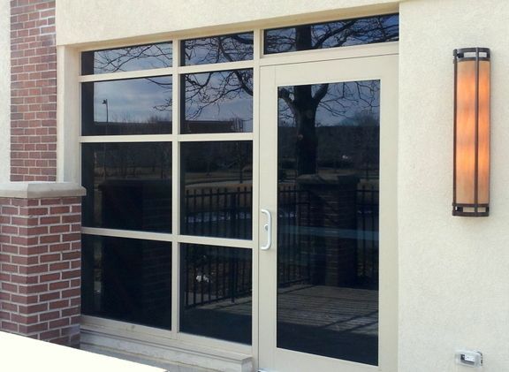 A white door with a brick wall behind it